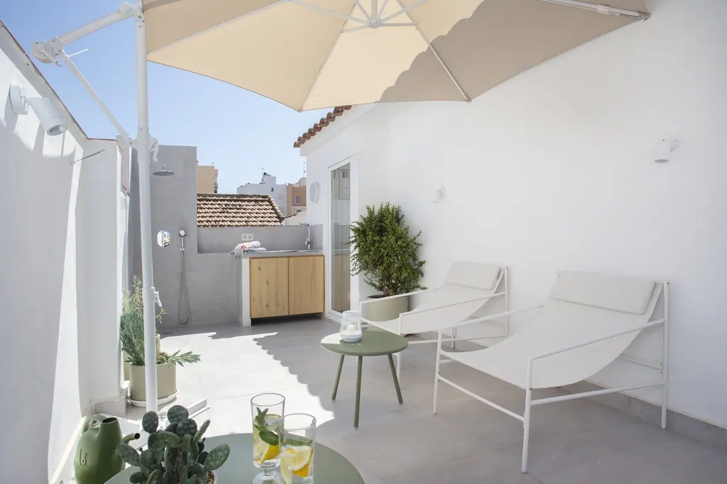 Casa Vacacional Terraza moderna minimalista blanca con tumbonas sombrilla y plantas decorativas