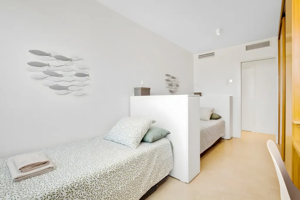 Ático en la Carihuela Dormitorio minimalista moderno con decoración blanca y detalles naturales